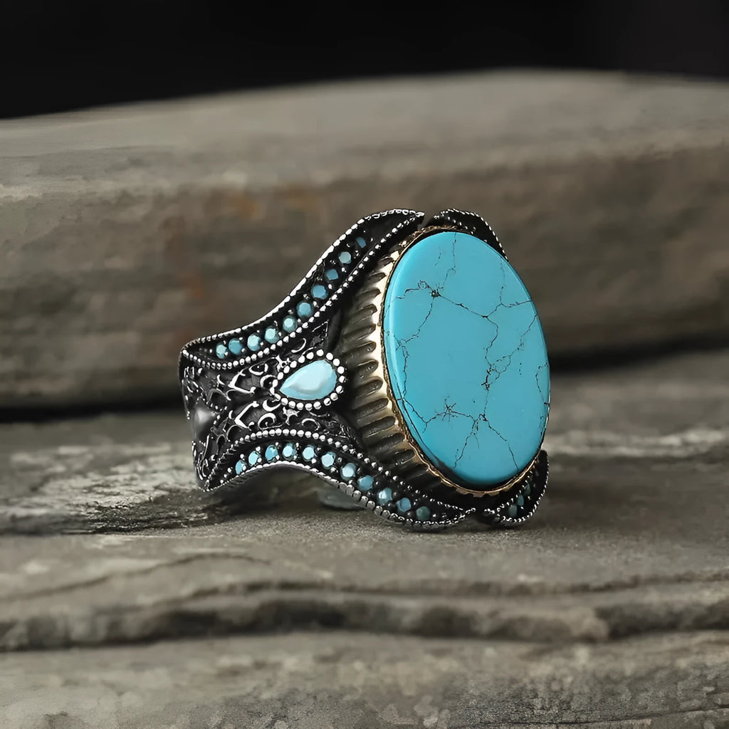 Men's antique silver turquoise ring showing round shape and polished metallic finish