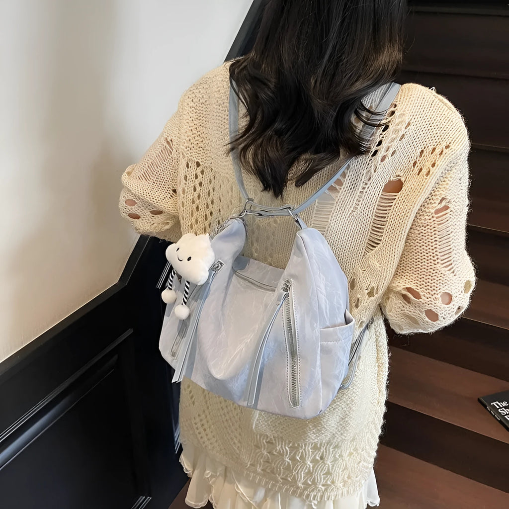 Women's soft PU fashion backpack with pendant accessory in black, milky white, silver or blue colour