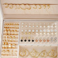 108 geometric pearl earrings in gold and yellow colours with round elements on alloy studs