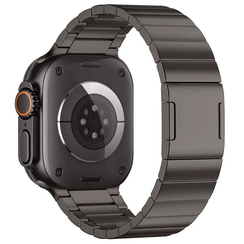 Stainless steel magnetic buckle Apple Watch replacement band in silver colour on a wrist.