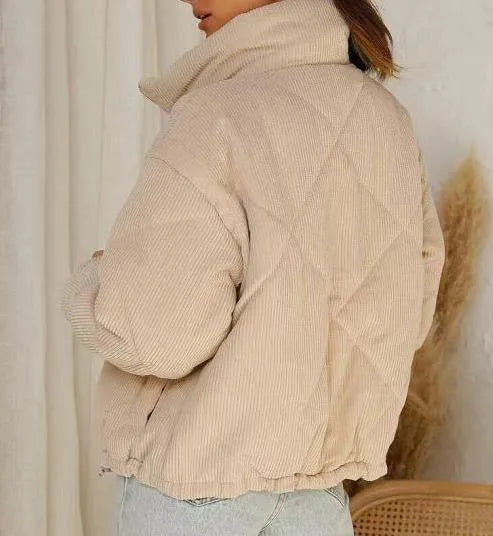 Apricot coloured women's corduroy jacket with stand collar, front zipper, and long sleeves.