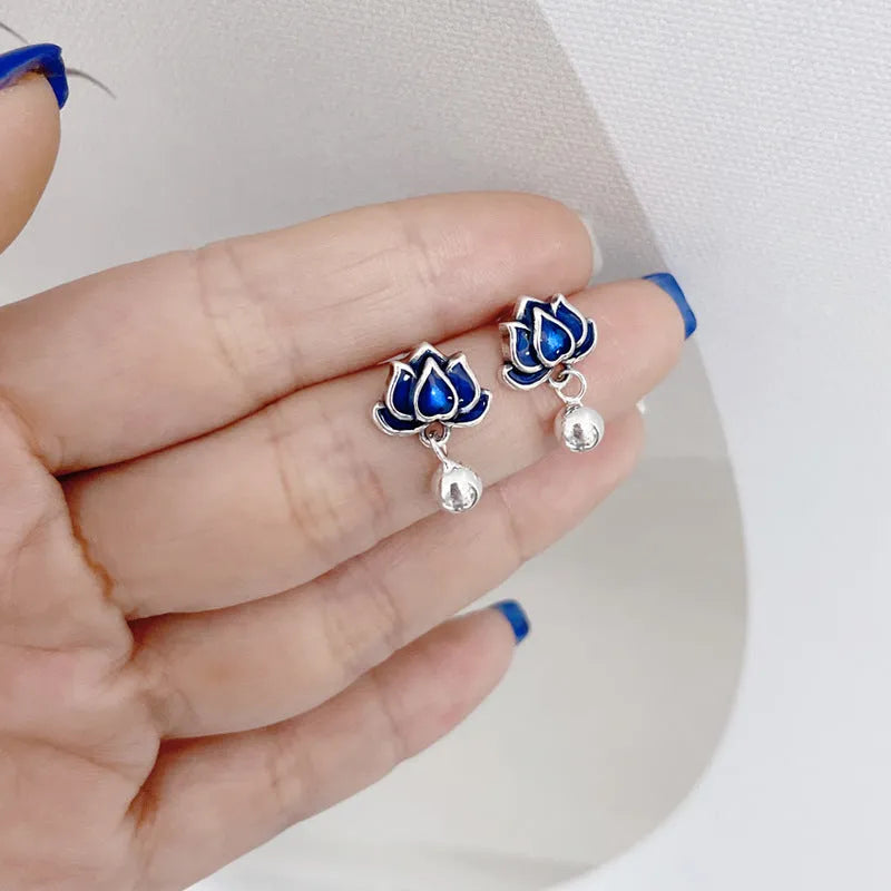 Close-up of alloy lotus ear studs with silver needle seedpod tassel design, showing 1.2cm width.
