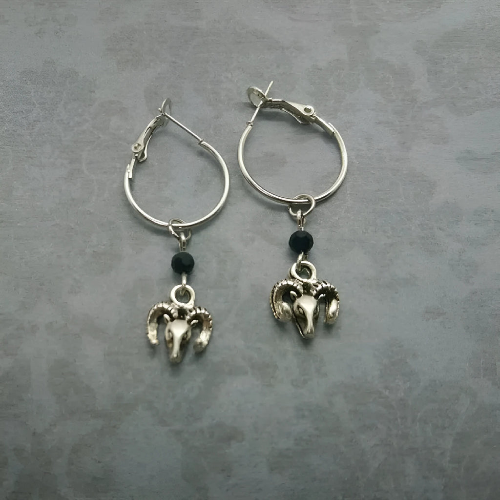 Silver round hoop earrings with a Tibetan antelope design motif for women.