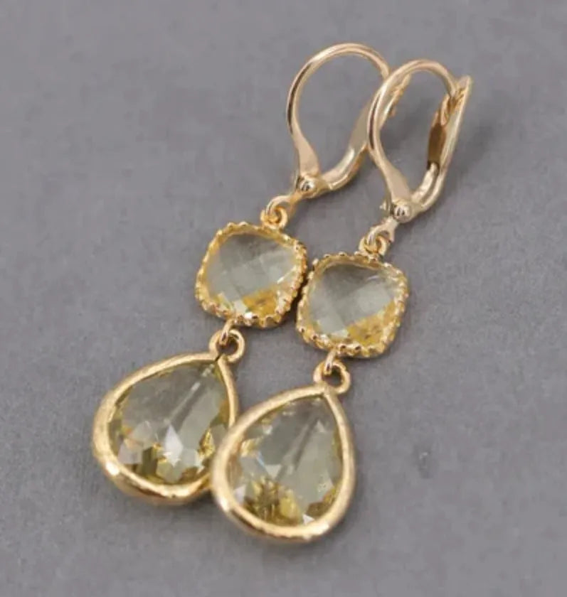 Geometric gold electroplated earrings with long crystal fringe and water droplet elements in retro style