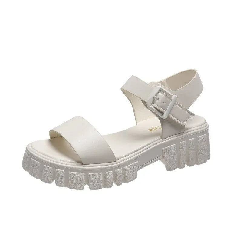 Women's beige peep toe ankle-strap buckle platform sandals with a fish mouth toe design on a wooden surface.