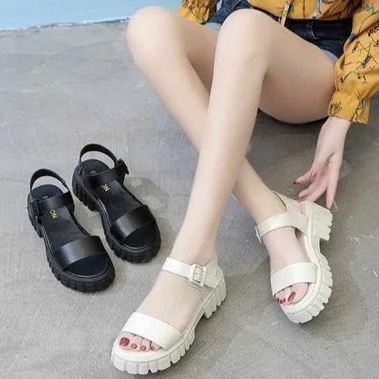 Women's beige peep toe ankle-strap buckle platform sandals with a fish mouth toe design on a wooden surface.