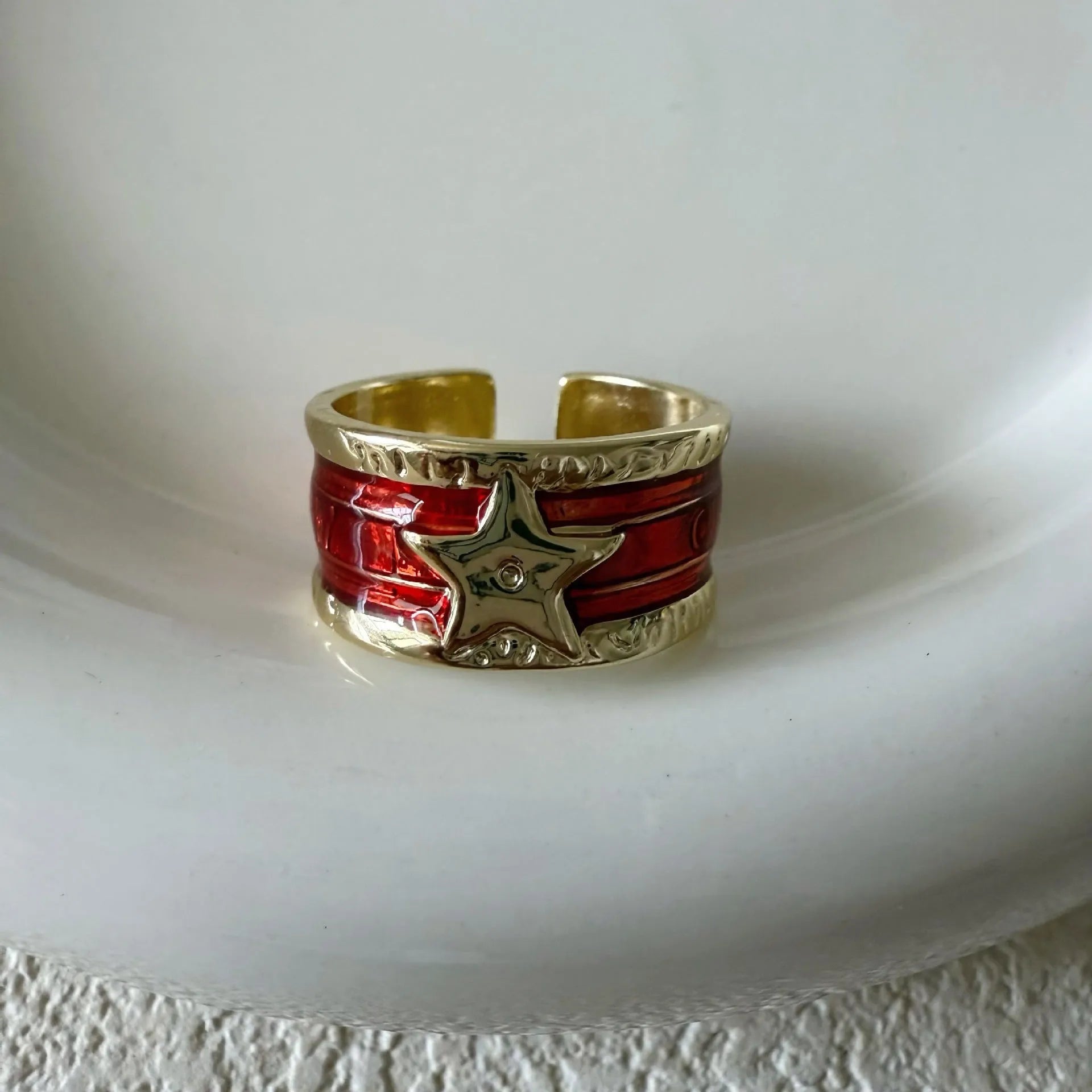 Geometric adjustable copper ring with a distressed finish in black, red, and blue colour options.