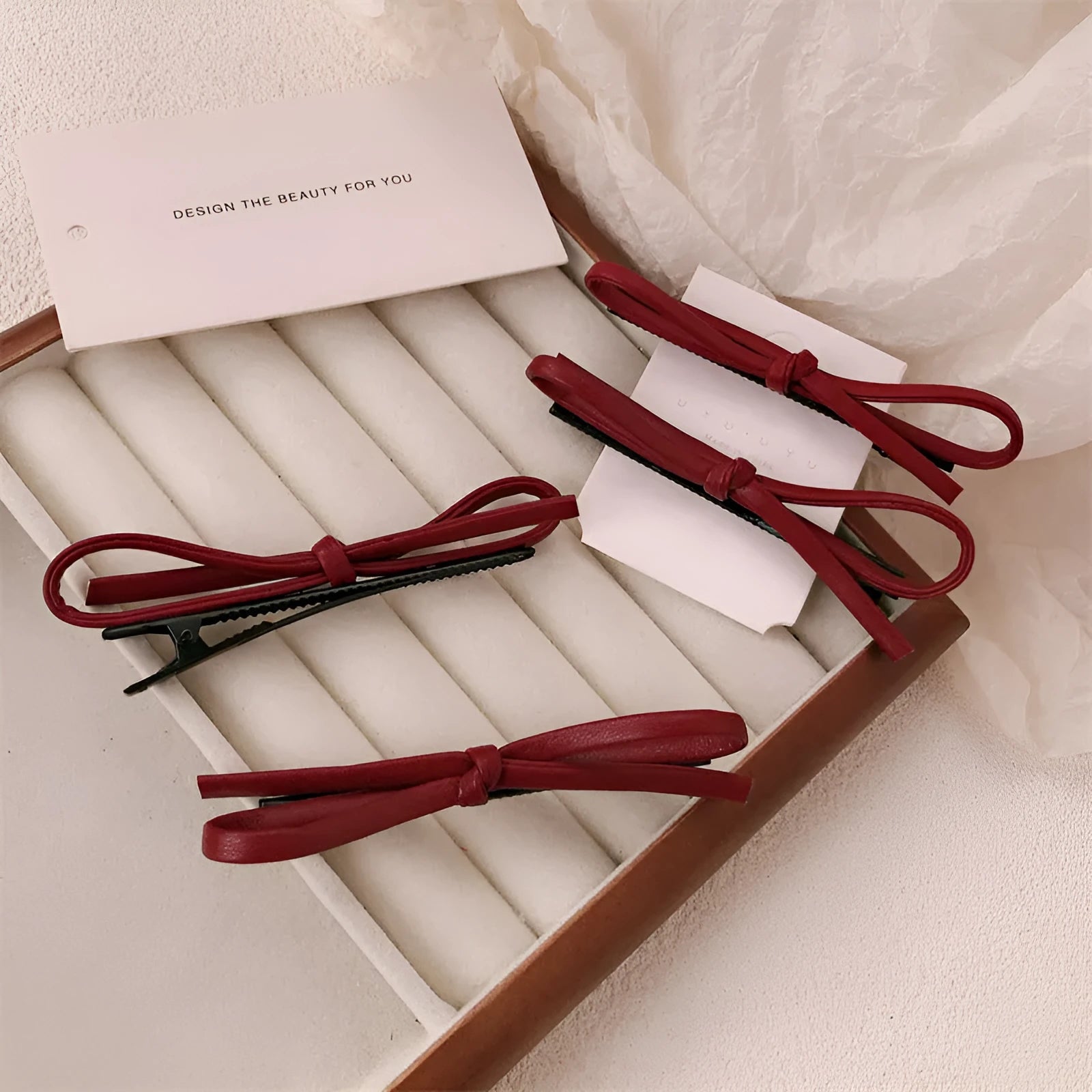 Wine red leather bow hair barrettes showing front and back views