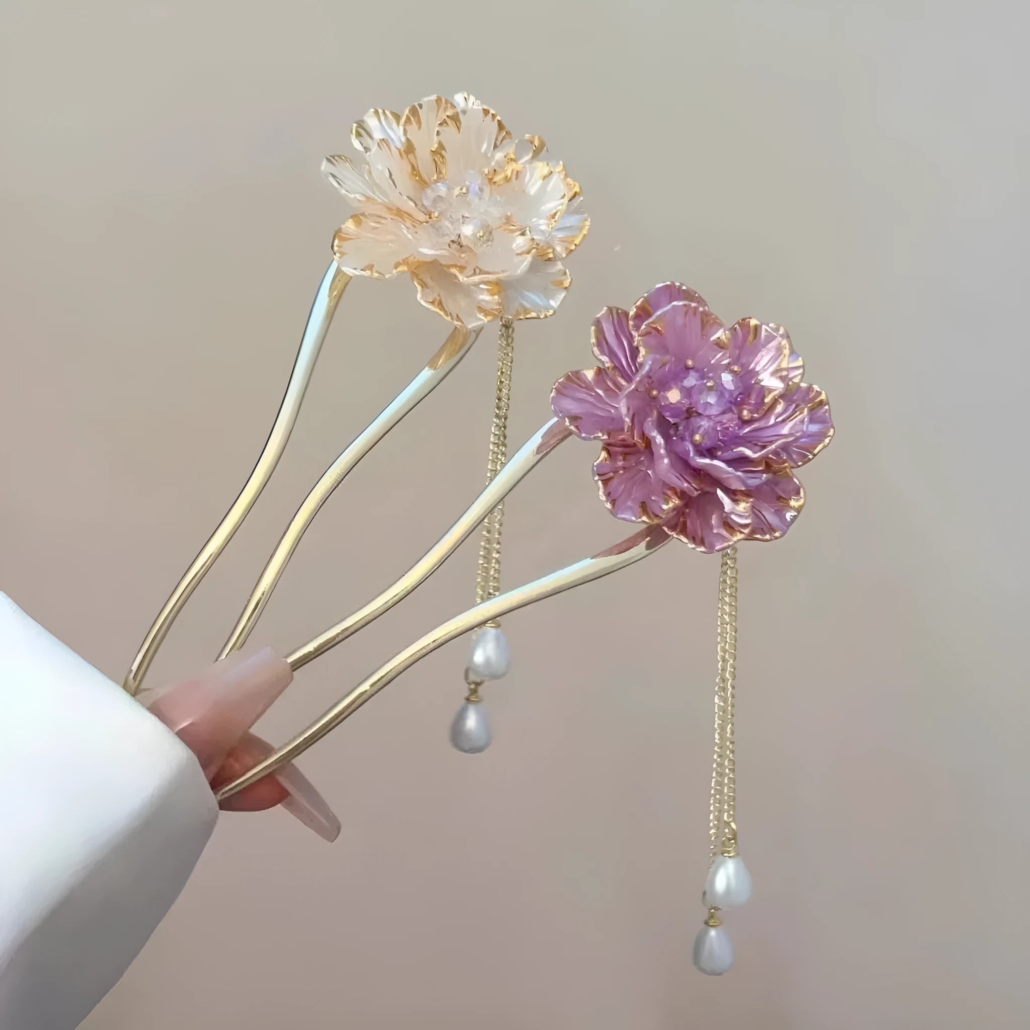 Close-up of a purple and white alloy U-shaped hairpin with a peony flower and tassel design.