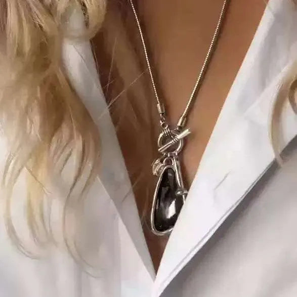 Long alloy sweater chain necklace with a geometric water drop pendant on a snake bone chain.