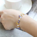 Women's adjustable bracelet with imitation pearls and coloured glass beads in a European design.