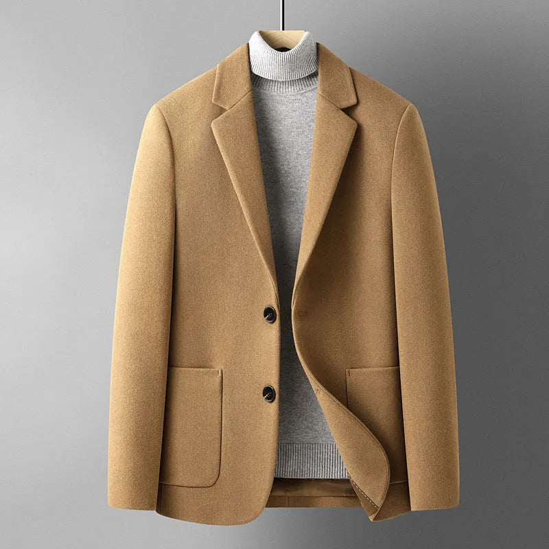 Men's slim fit wool suit jacket in grey on a hanger, showing notch lapel and button front.