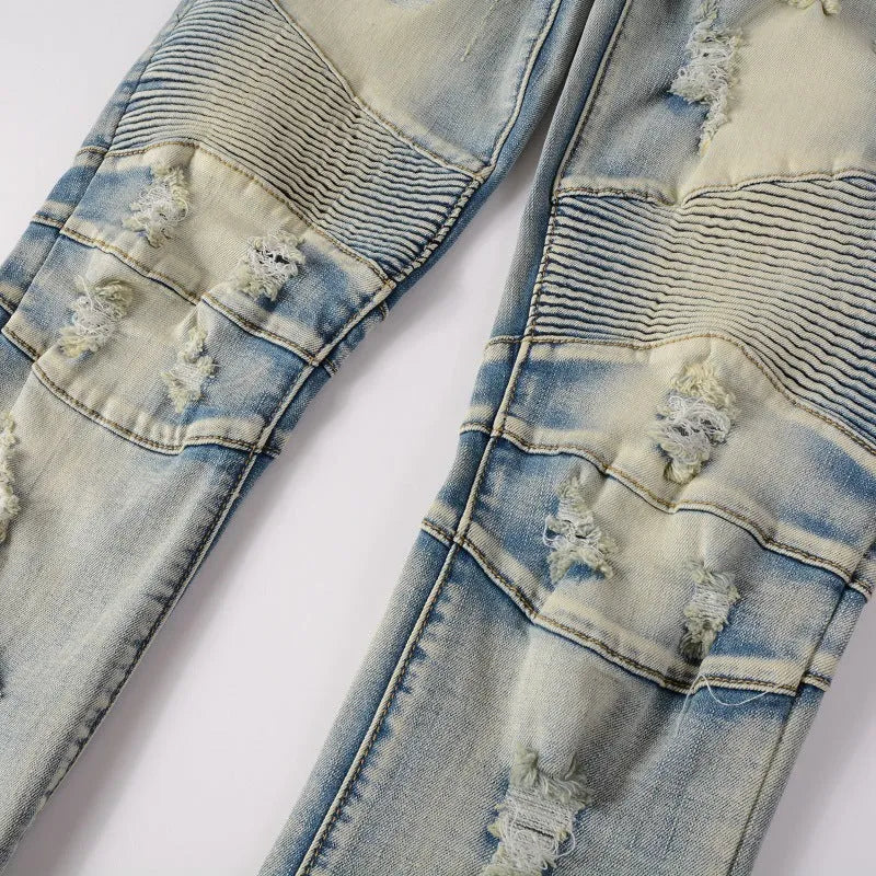Light blue distressed men's slim fit jeans with hand-frayed rips and a straight leg cut.