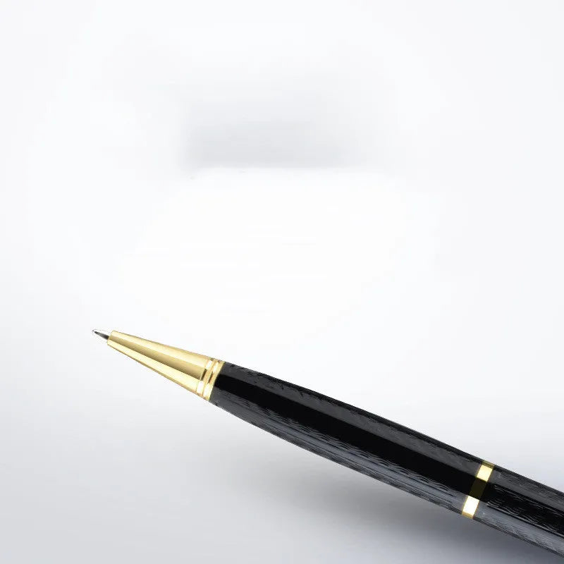 Black pen-shaped audio recorder with zinc alloy body, shown next to its included headset and data cable.