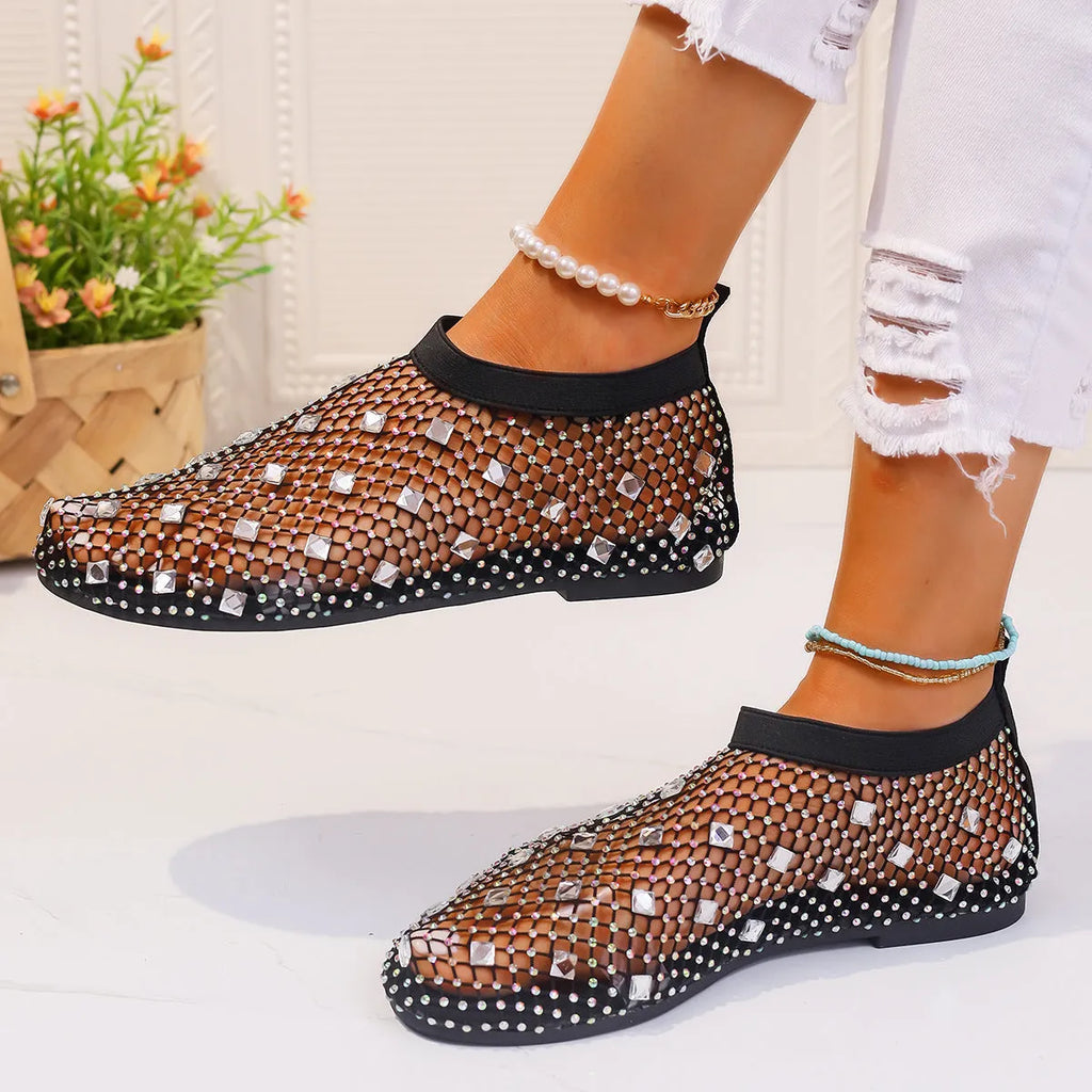 Colourful rhinestone detail on women's mesh flat sandals with round toe and rubber sole.