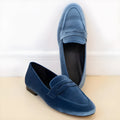 Blue plus size suede loafers with round toe and black rubber sole on a white background.