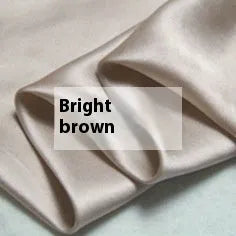 Solid colour double-sided silk duvet cover shown in bright brown, with other colour swatches for Lotus Pink, pea green, mysterious purple, white, and silver blue.