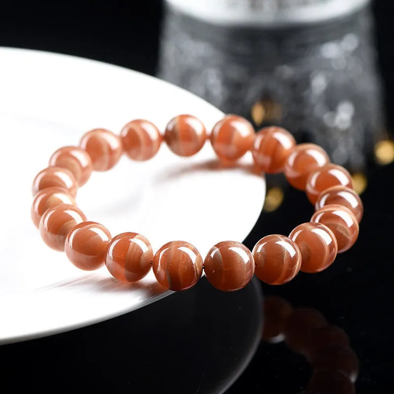 Natural Old Mine rhodochrosite mineral bracelet with round manganese spar beads in geometric design.