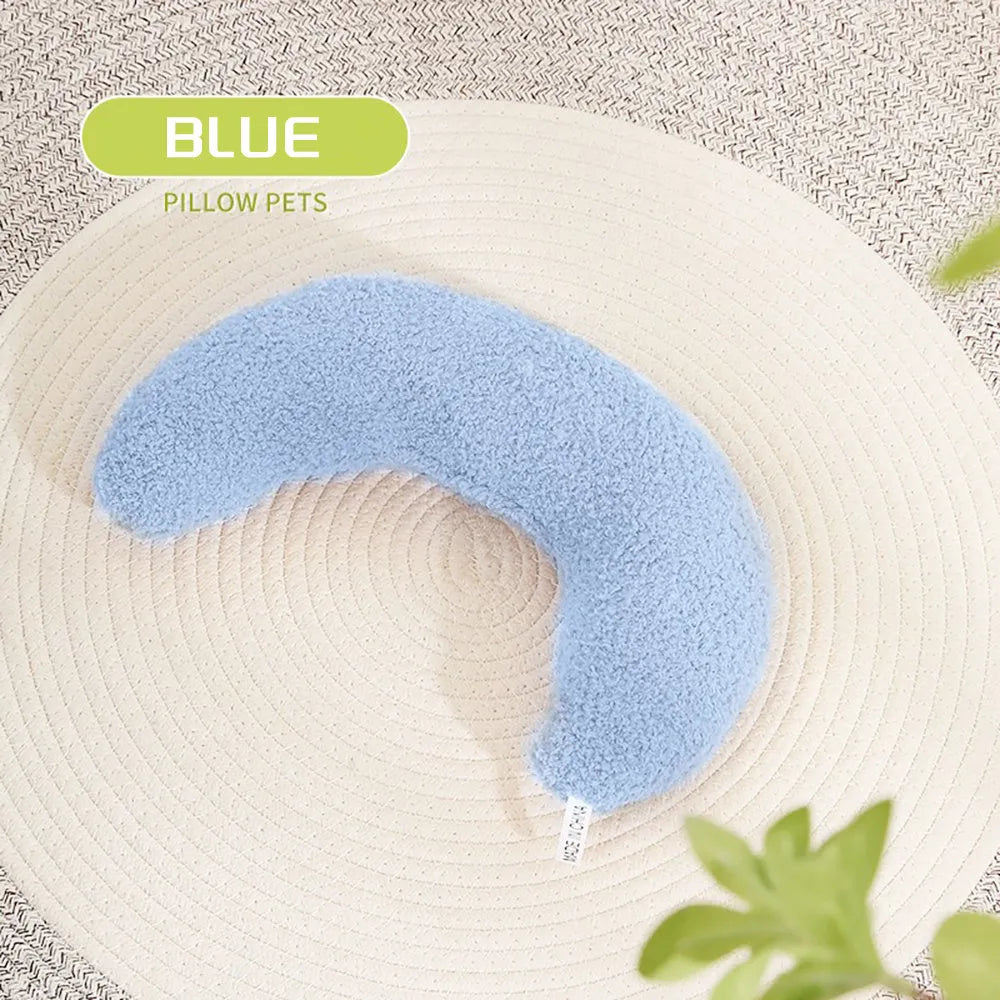 Blue U-shaped cat pillow with an adjustable fabric collar for neck support on a grey sofa