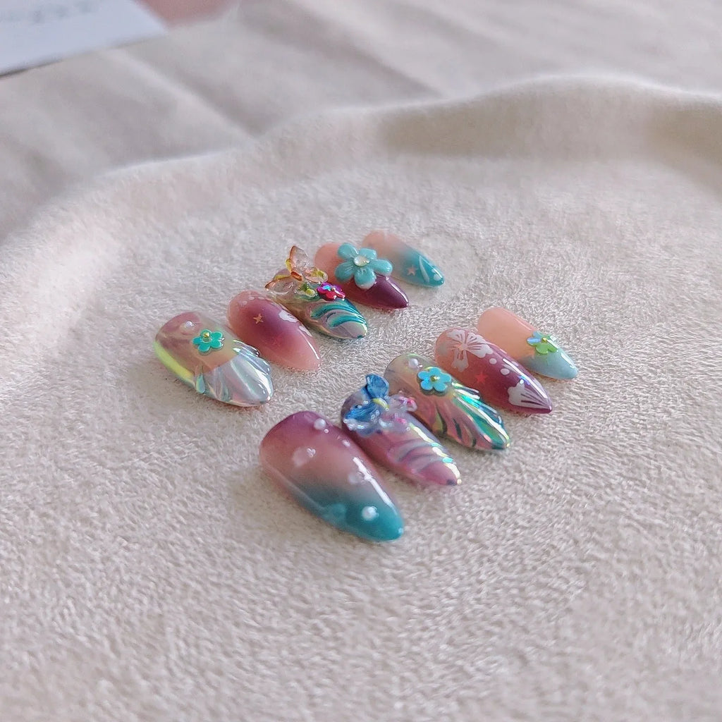 Handmade embossed nail art stickers showing floral and butterfly patterns in almond shape