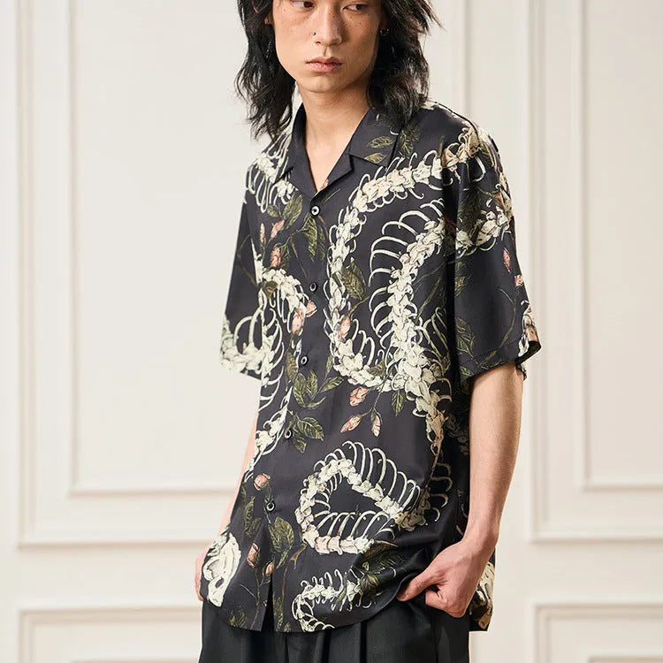 Men's short sleeve Cuban collar shirt featuring a snake bone and floral printed pattern in a loose fit.