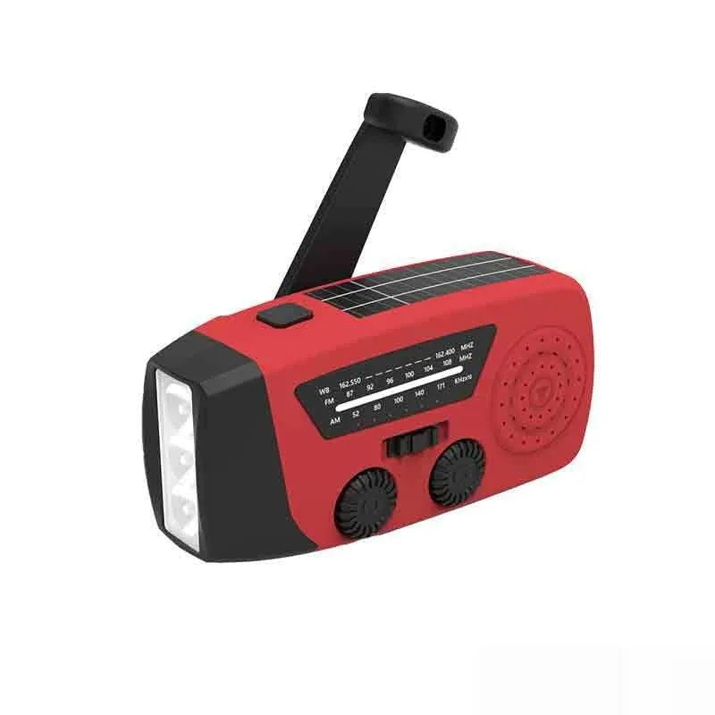 Red rechargeable emergency hand radio with torch, built-in speaker, USB port, and wrist strap.