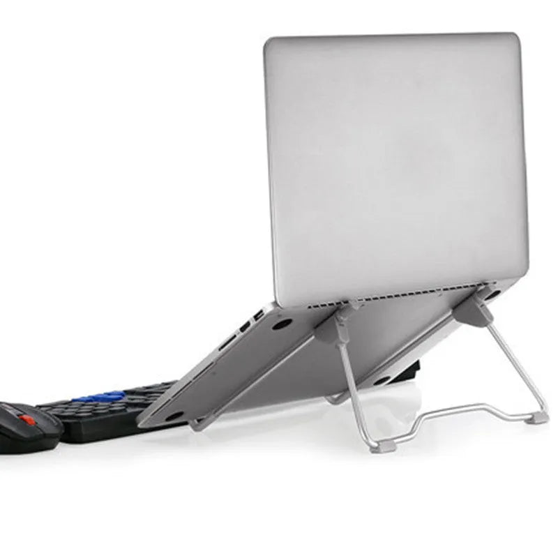 Grey aluminium and plastic adjustable stand holding a mobile phone and a laptop on a desk.