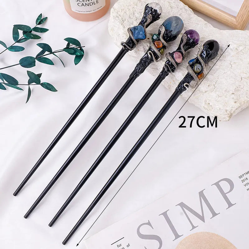 Natural crystal ball truncheon magic wand with amethyst stone ball on dark background