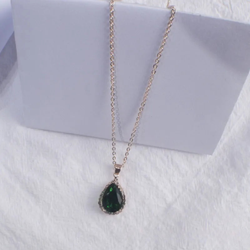 Rose gold electroplated necklace with water drop shaped geometric pendant and rhinestone detailing