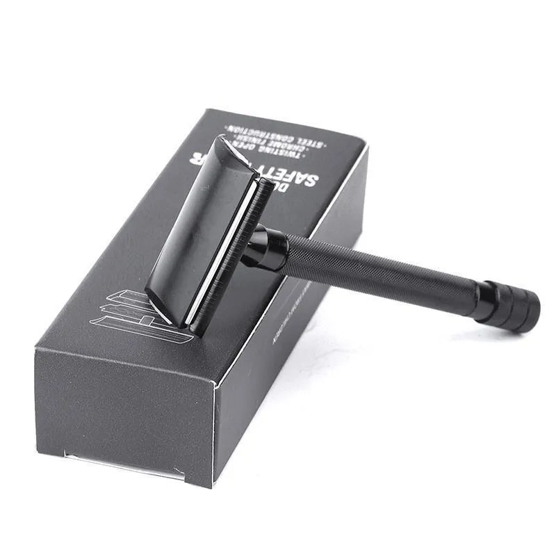 Traditional manual shaving razor and brush set in silver and black finish on a wooden surface.
