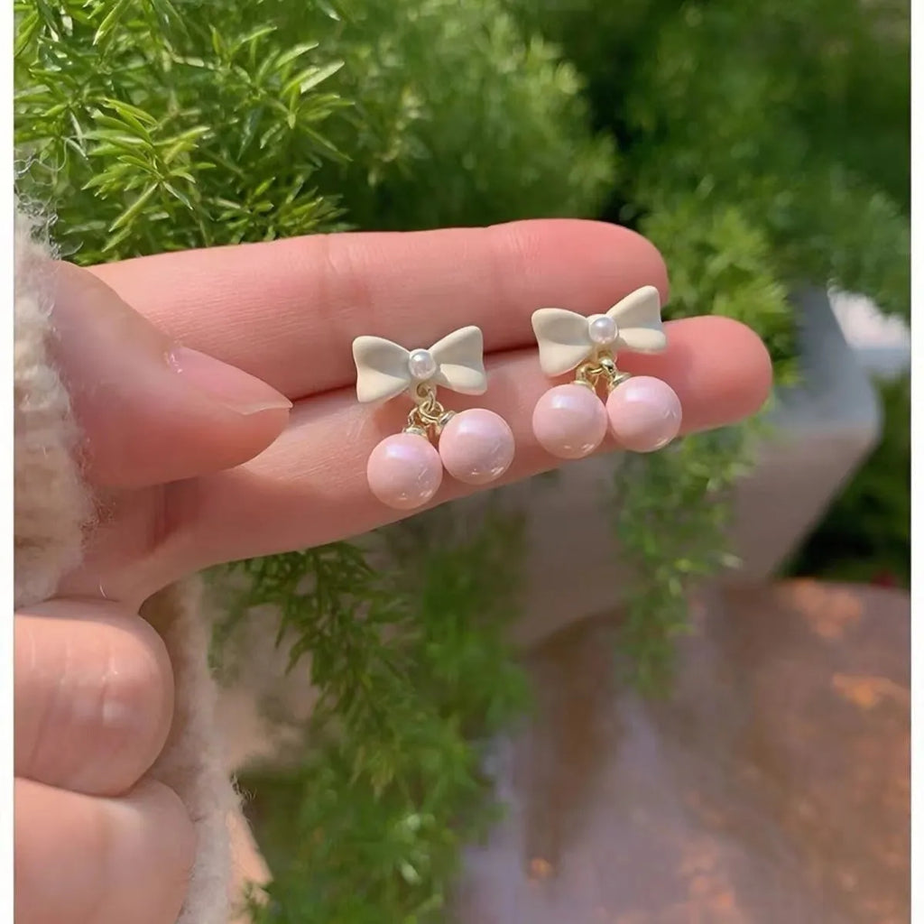 Pink heart pearl bow earrings on alloy with electroplated finish, silver needle style