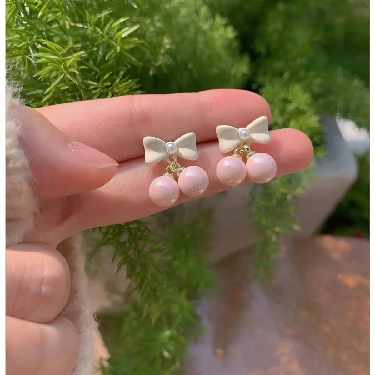 Pink heart pearl bow earrings on alloy with electroplated finish, silver needle style