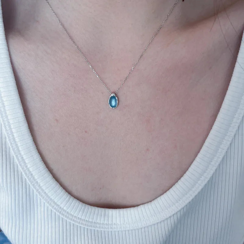 Navy blue water drop pendant necklace with adjustable cross chain in platinum colour