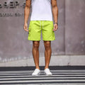 Men's loose fit workwear shorts in army green and fluorescent green colours with straight leg street style design