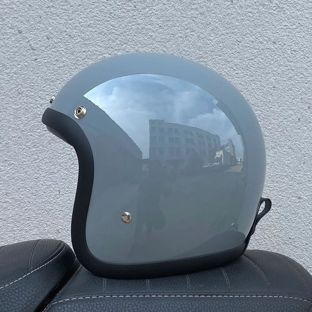 A cement grey retro-style half motorcycle helmet made from FRP glass fibre, shown on a white background.