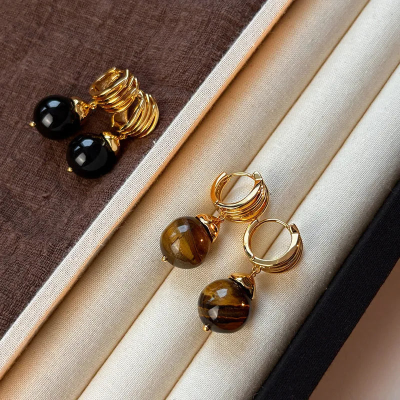 Geometric round tigereye stone earrings for women with gold plating in black and brown.