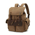Retro military green canvas backpack with antique bronze hardware, shown with a laptop.