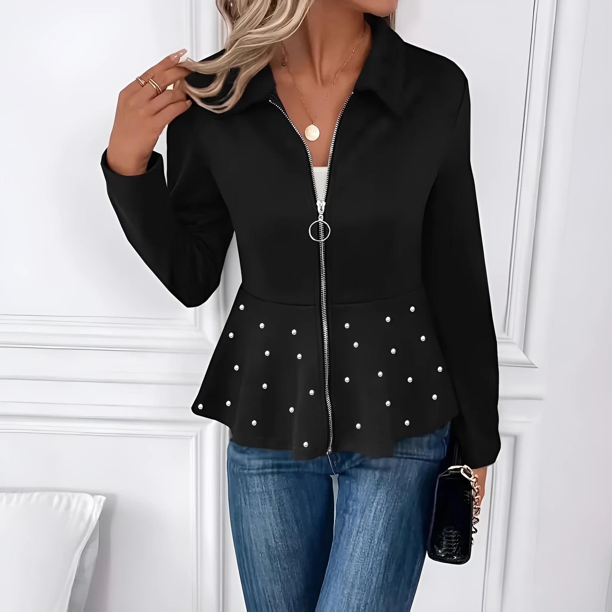 Women's black loose-fit coat with heavy-duty front zipper and ruffle hem detail.