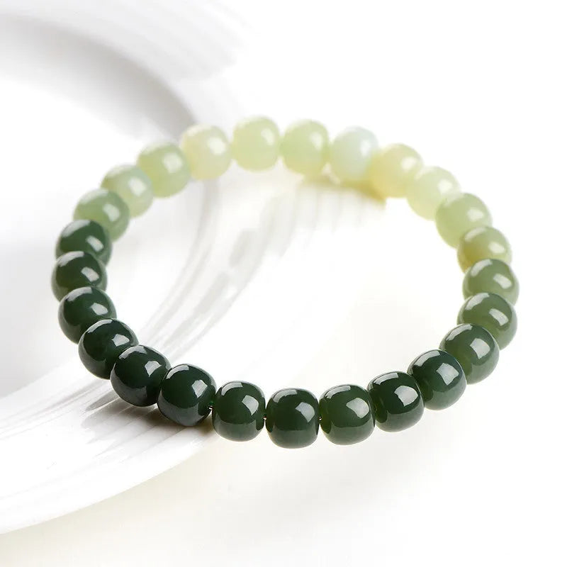 Natural Hetian jade bracelet showing a sunny water gradient colour on polished beads.