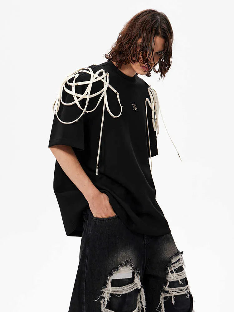 Black loose-fit short-sleeved t-shirt showing padded shoulder detail with rivet ribbon.