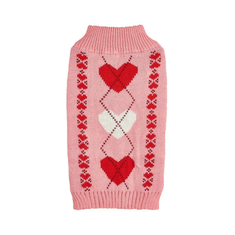 Red love heart design dog sweater on a small dog, showing pink bow detail.