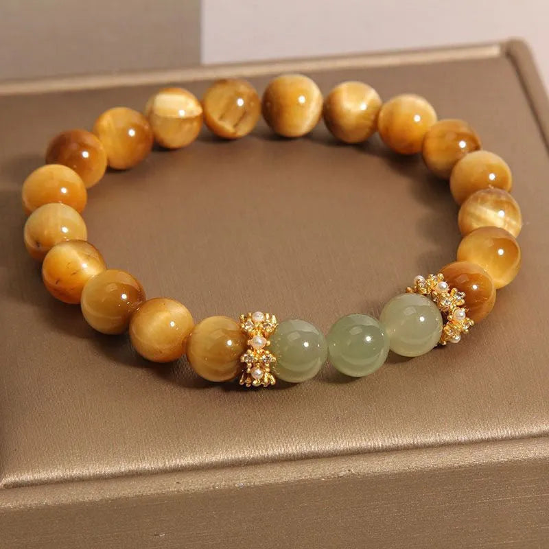 Natural yellow tiger's eye and Hetian jade bead bracelet in a U-shape, showing golden gourd design.