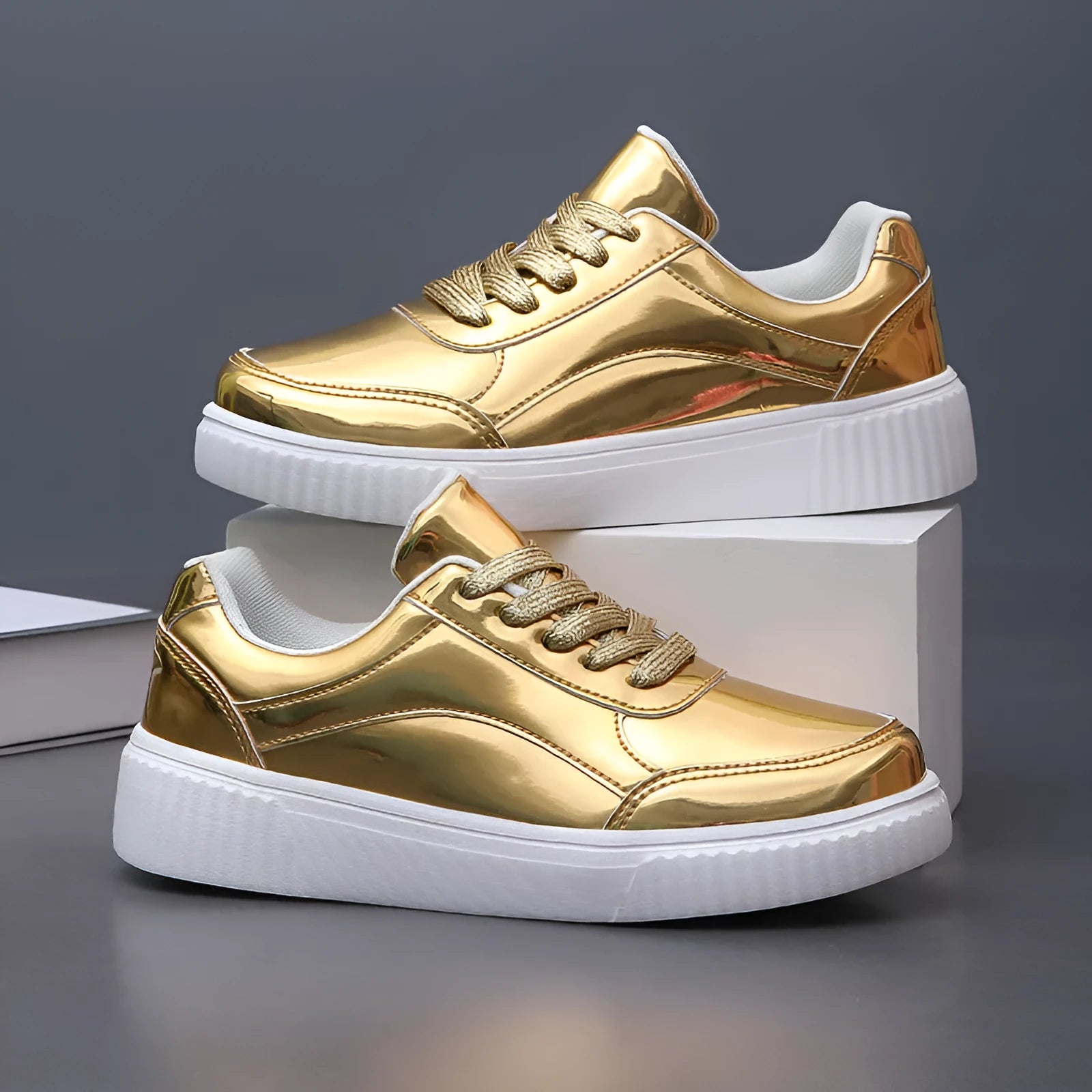 Gold sequinned unisex platform sneaker with thick sole and stitching detail on a white background.
