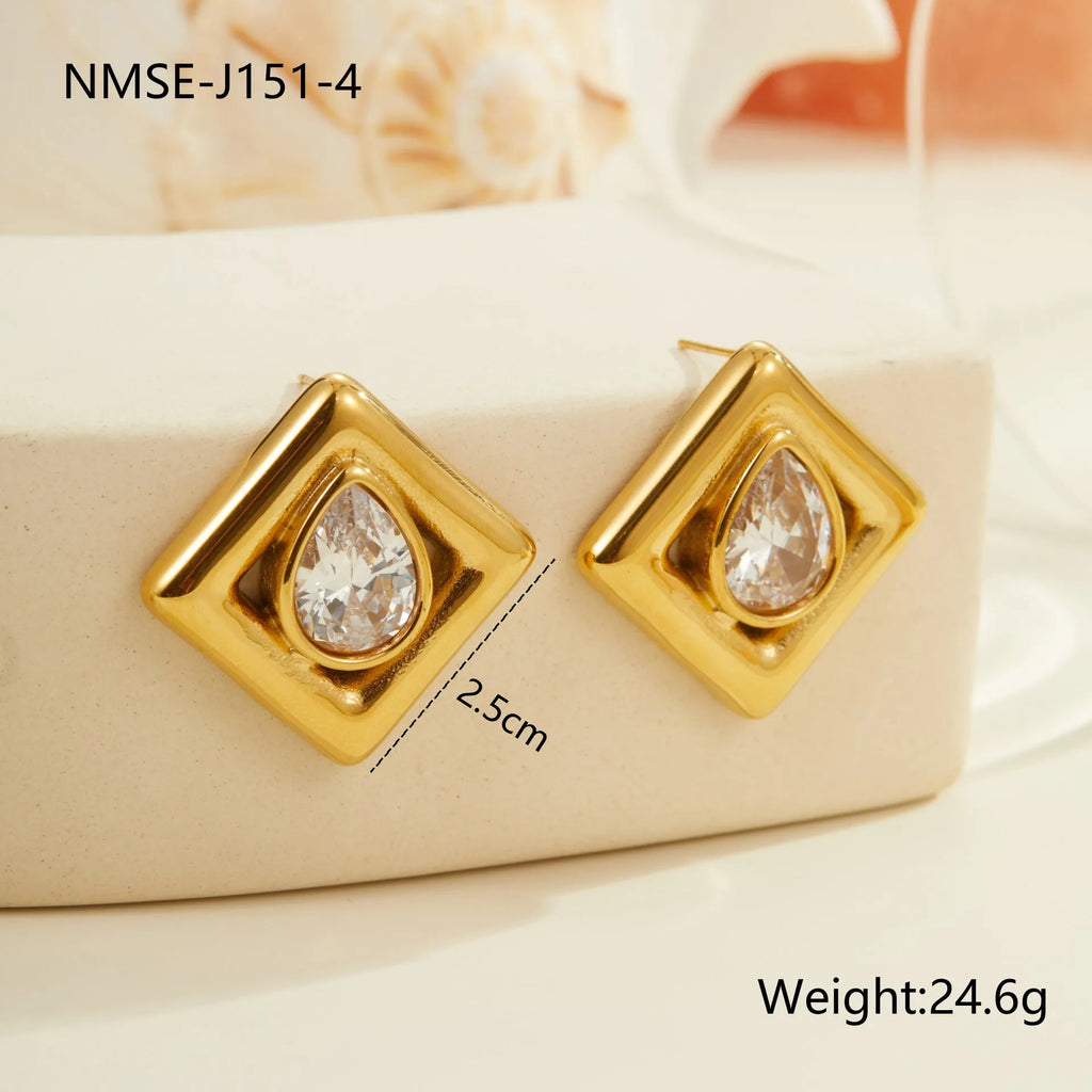 Gold geometric water drop shaped stud earrings with a central zircon stone inlay.