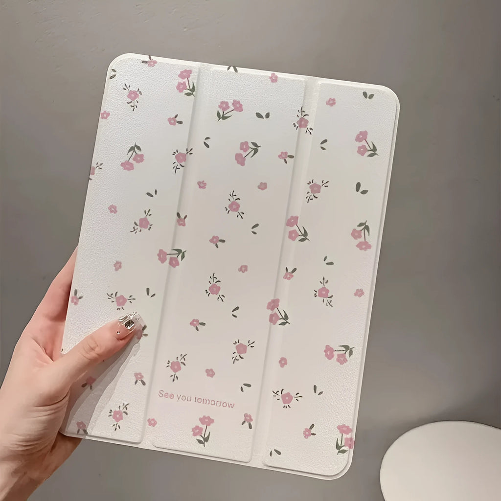Transparent floral patterned tri-fold hard case for Apple iPad showing stand angle.