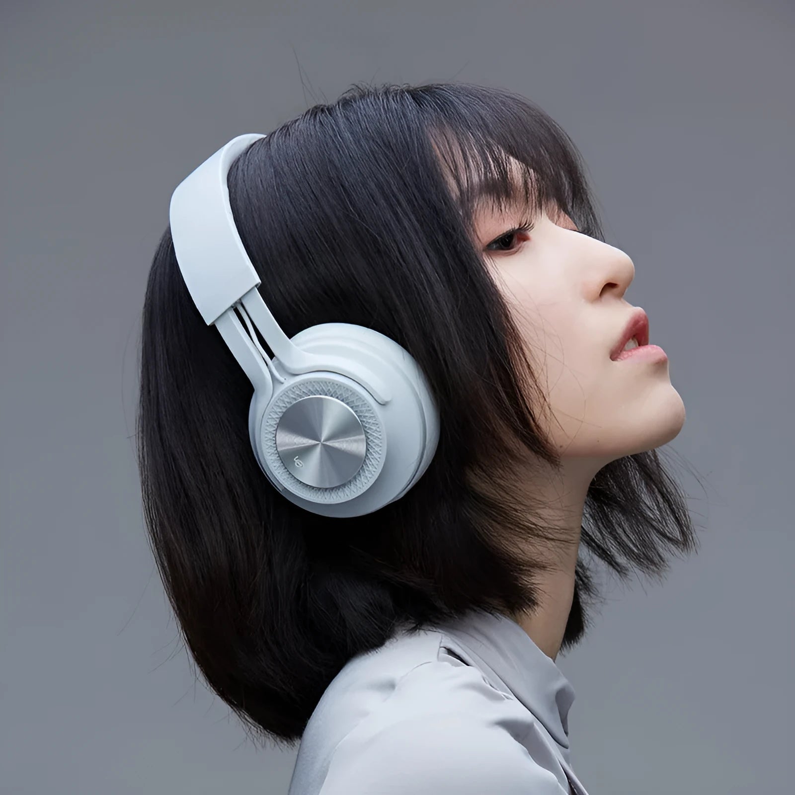 Red sports wireless Bluetooth headset with over-ear design on a white background.