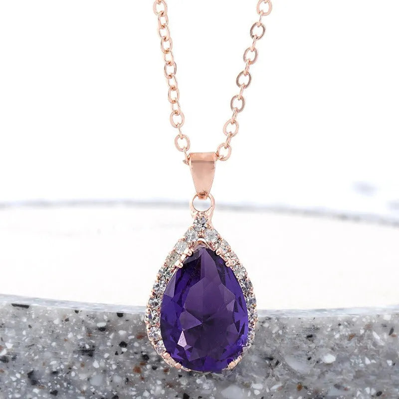 Rose gold electroplated necklace with water drop shaped geometric pendant and rhinestone detailing