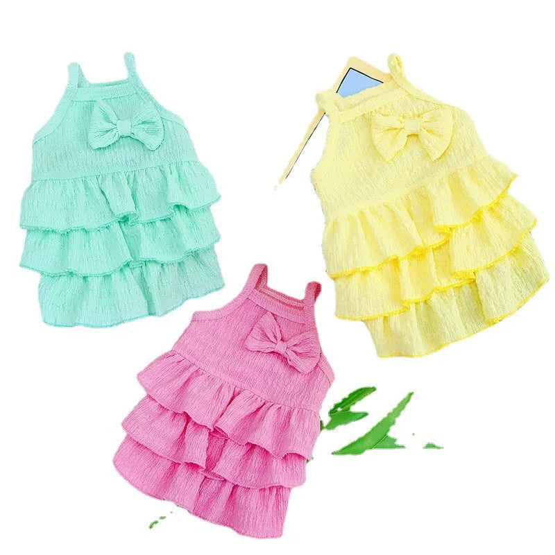 Small dog wearing polyester princess dress with layered skirt in candy colours