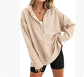 Women's loose fit raglan sleeve sweater in peacock green colour on a hanger.