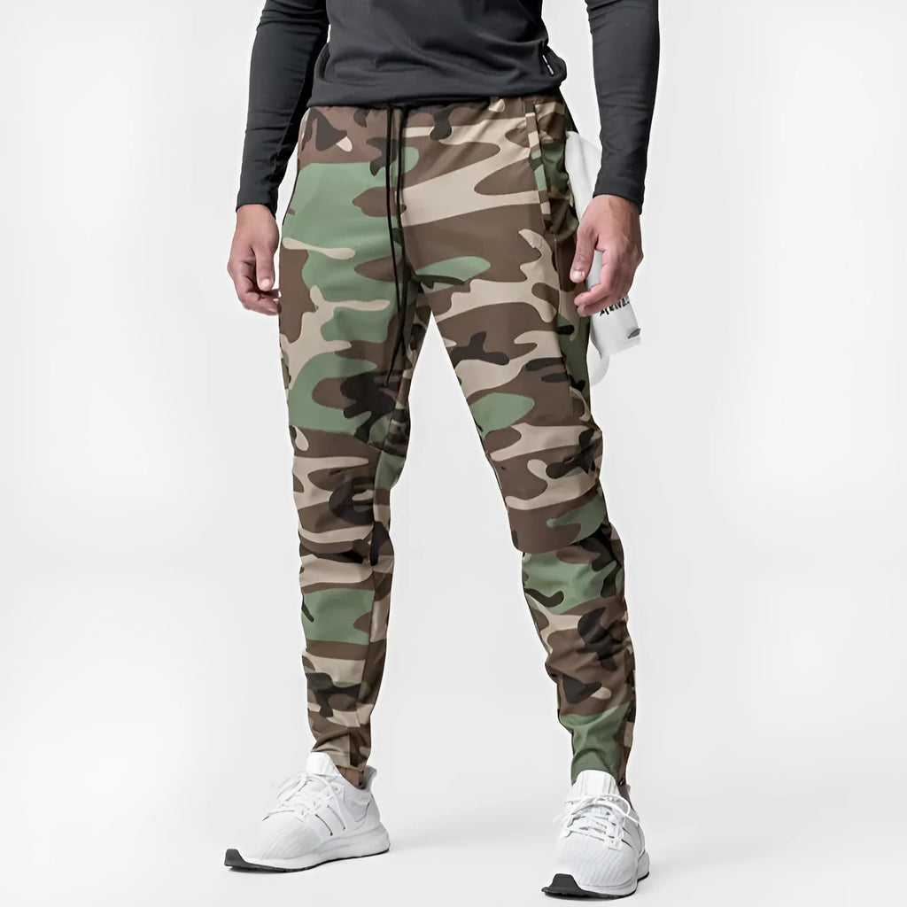 Men's ankle-tied loose fit running pants in a quick-dry fabric, shown in olive green colour.